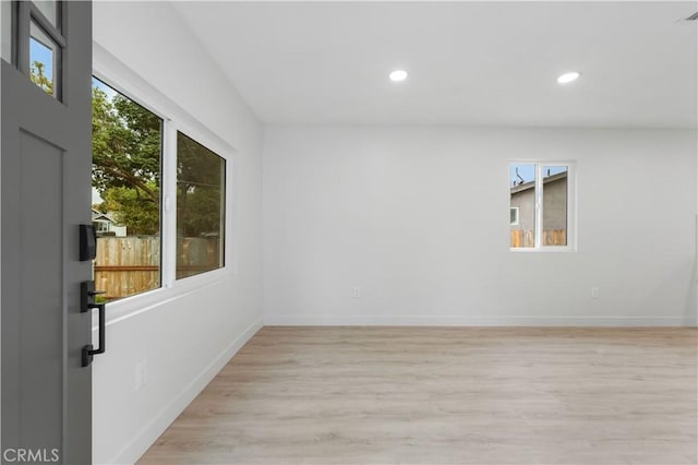 spare room with light hardwood / wood-style flooring and a healthy amount of sunlight