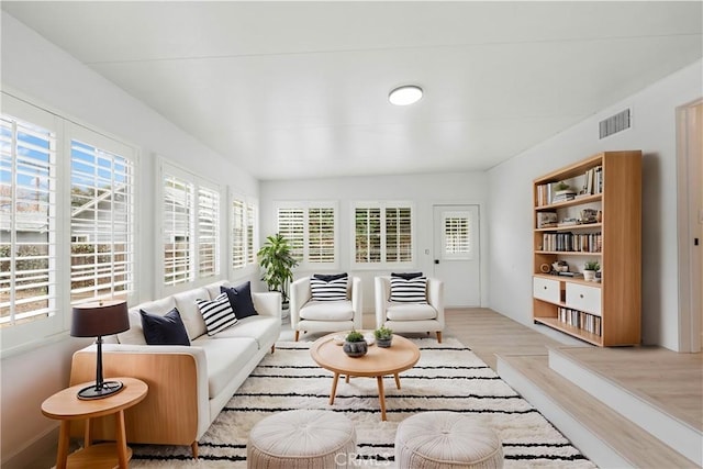 living room with plenty of natural light and light hardwood / wood-style floors