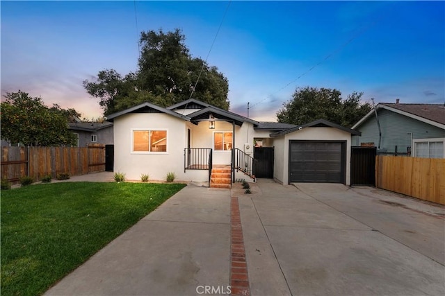 view of front of home with a lawn and a garage