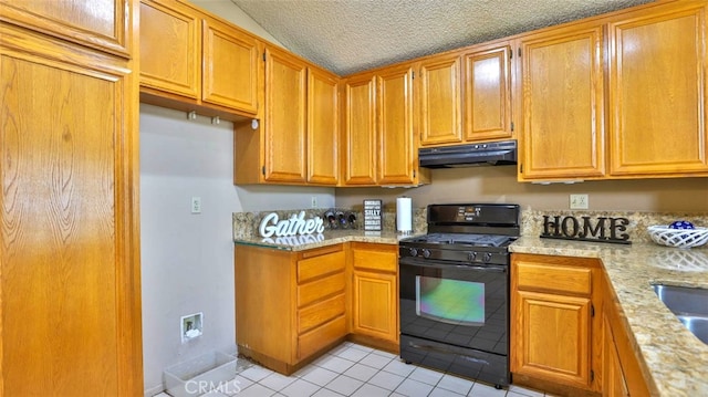 kitchen featuring light stone counters, black gas range oven, a textured ceiling, vaulted ceiling, and light tile patterned flooring