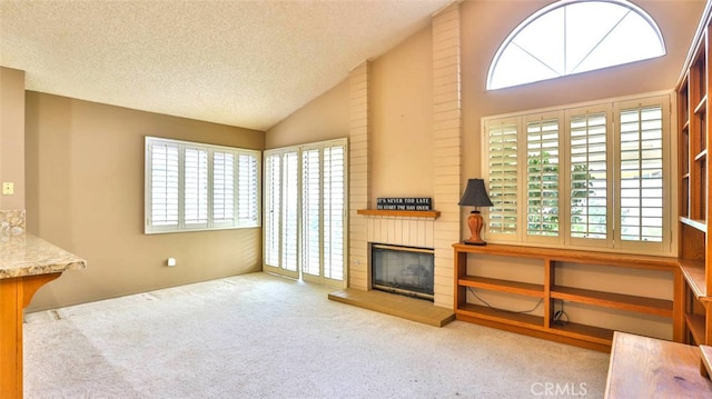 living room featuring light carpet, a fireplace, high vaulted ceiling, and a textured ceiling