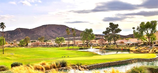 surrounding community with a yard and a water and mountain view