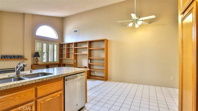 kitchen with sink, high vaulted ceiling, stainless steel dishwasher, and a textured ceiling