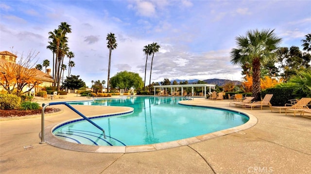 view of pool featuring a mountain view and a patio