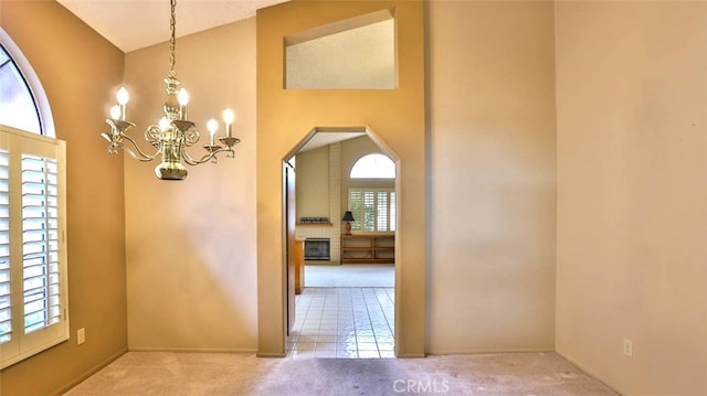 interior space featuring carpet flooring, a wealth of natural light, and a high ceiling