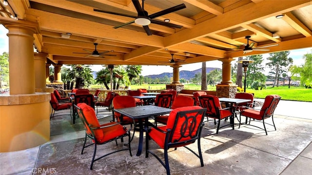 view of patio featuring a mountain view and ceiling fan