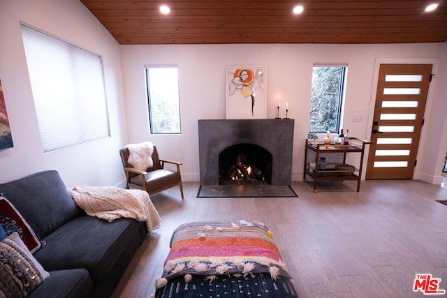 living room featuring a healthy amount of sunlight, wooden ceiling, vaulted ceiling, and wood-type flooring