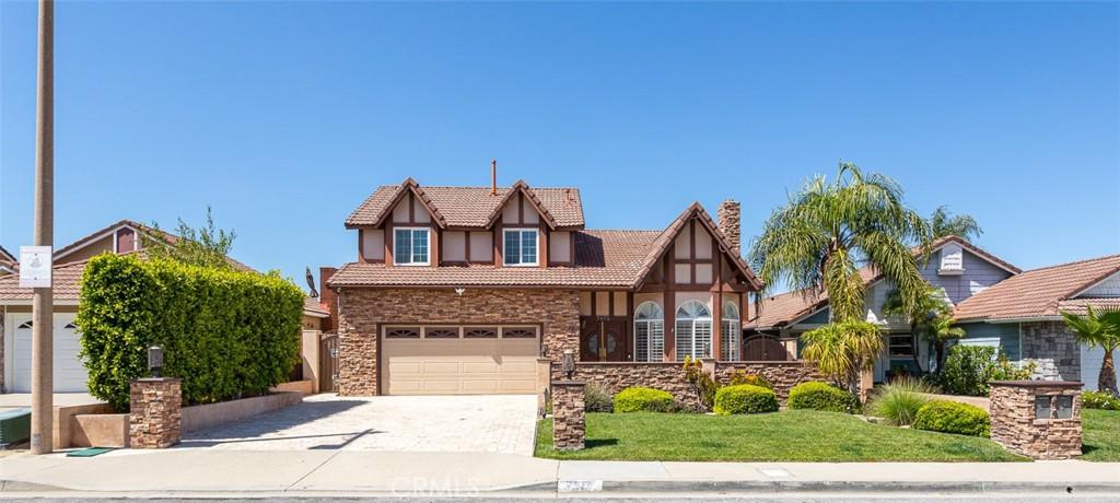 tudor house featuring a front yard and a garage