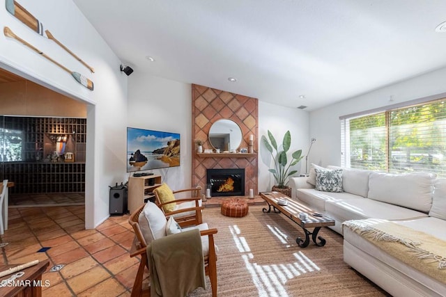 living room featuring light tile patterned floors and a tiled fireplace