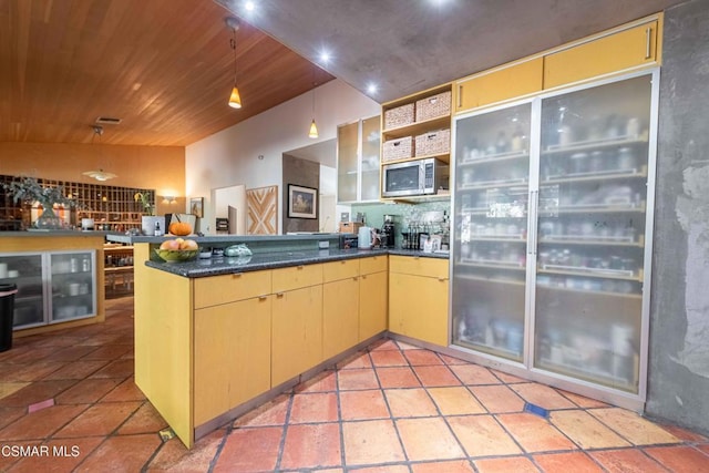 kitchen featuring decorative light fixtures, kitchen peninsula, and wood ceiling