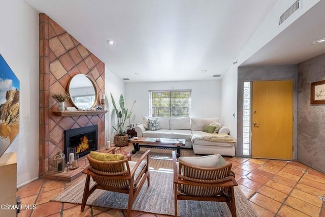 tiled living room featuring a fireplace