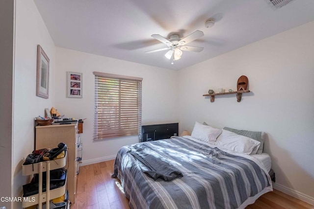 bedroom featuring ceiling fan and hardwood / wood-style flooring