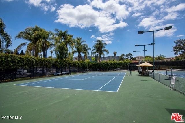 view of tennis court featuring basketball hoop