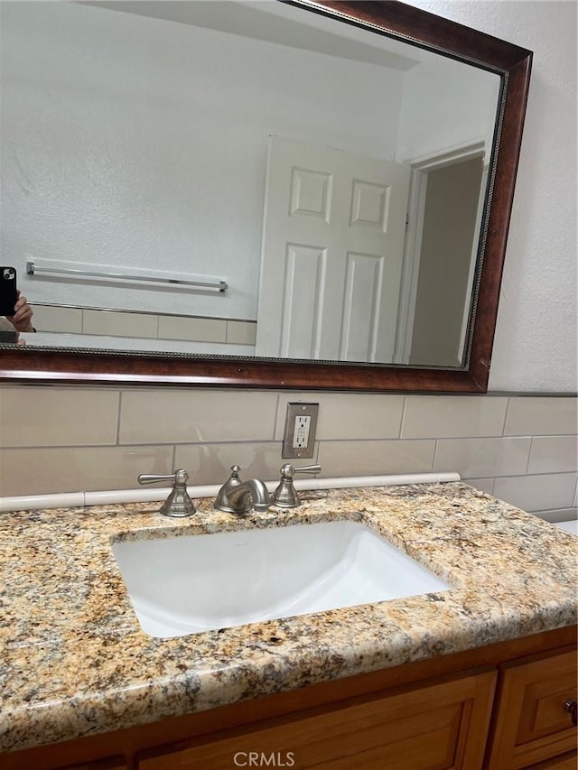 bathroom with backsplash and vanity