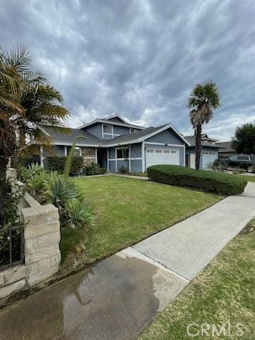 view of front facade with a garage and a front lawn