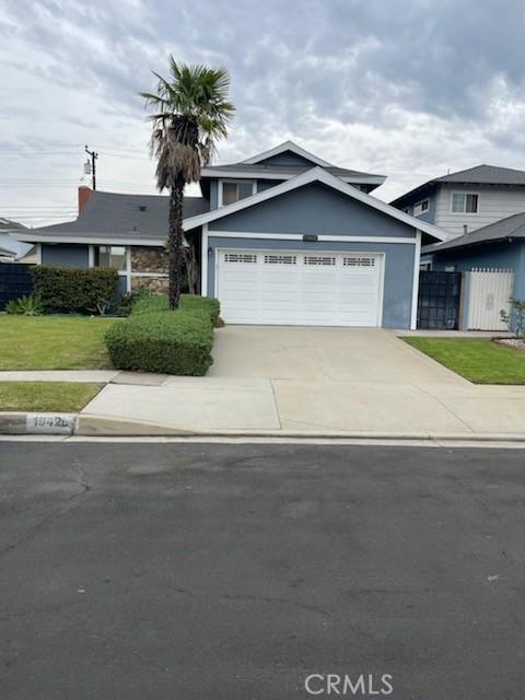 view of front of property featuring a garage and a front lawn