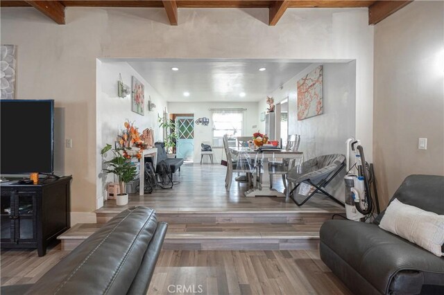 living room with hardwood / wood-style flooring and beam ceiling