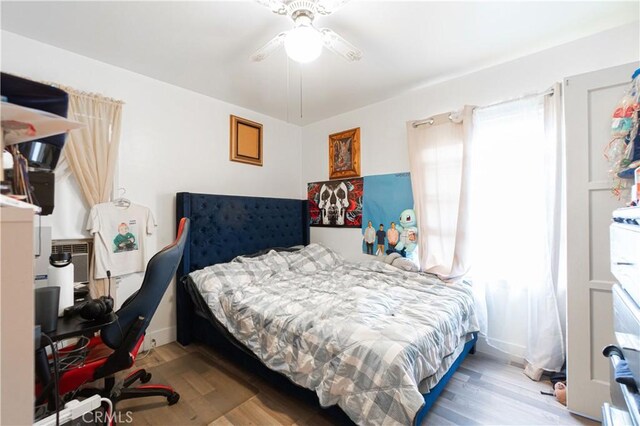 bedroom featuring hardwood / wood-style floors and ceiling fan