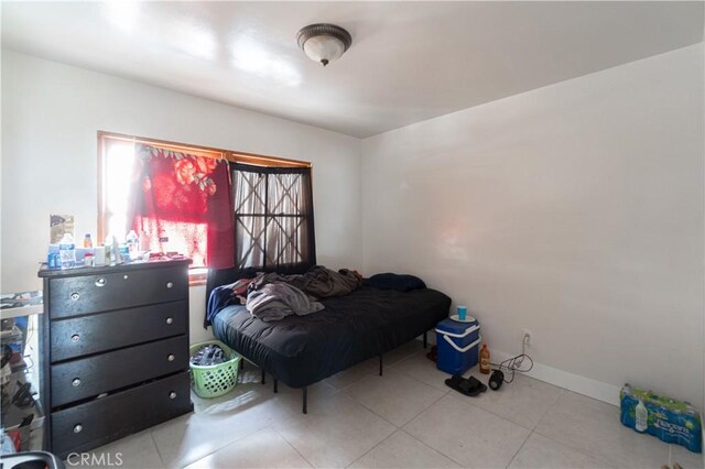 bedroom with light tile patterned floors