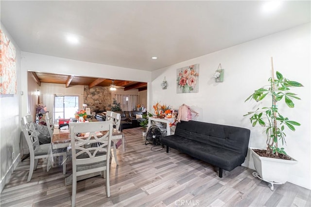 dining area featuring ceiling fan, lofted ceiling with beams, and wood-type flooring