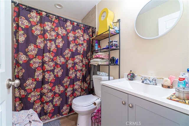 bathroom featuring vanity and toilet