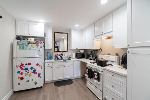 kitchen featuring white cabinets, light wood-type flooring, white appliances, and sink