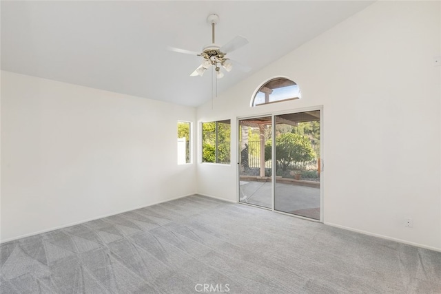 empty room with light colored carpet, high vaulted ceiling, and ceiling fan