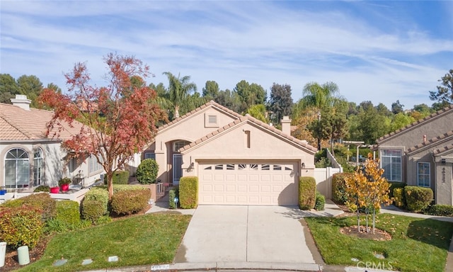 view of front of property featuring a front yard and a garage