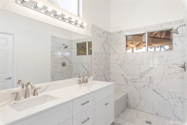 bathroom with vanity and tiled shower