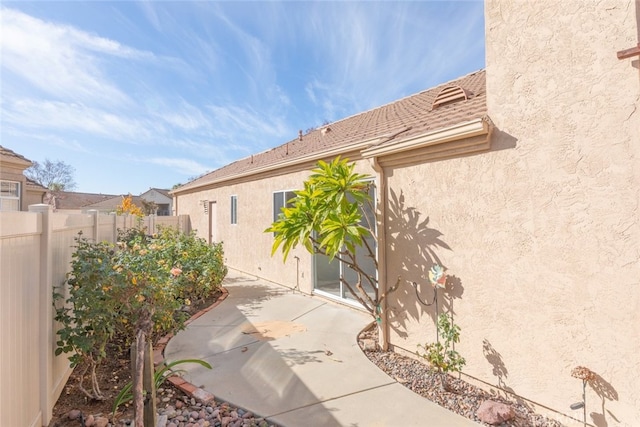 view of side of property featuring a patio area