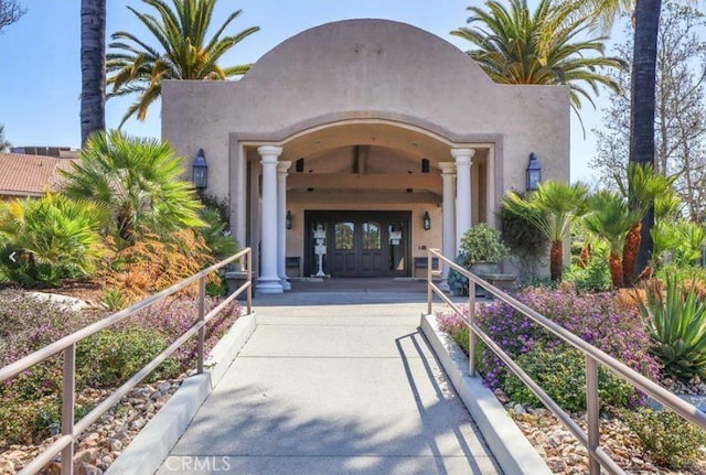 view of exterior entry featuring french doors