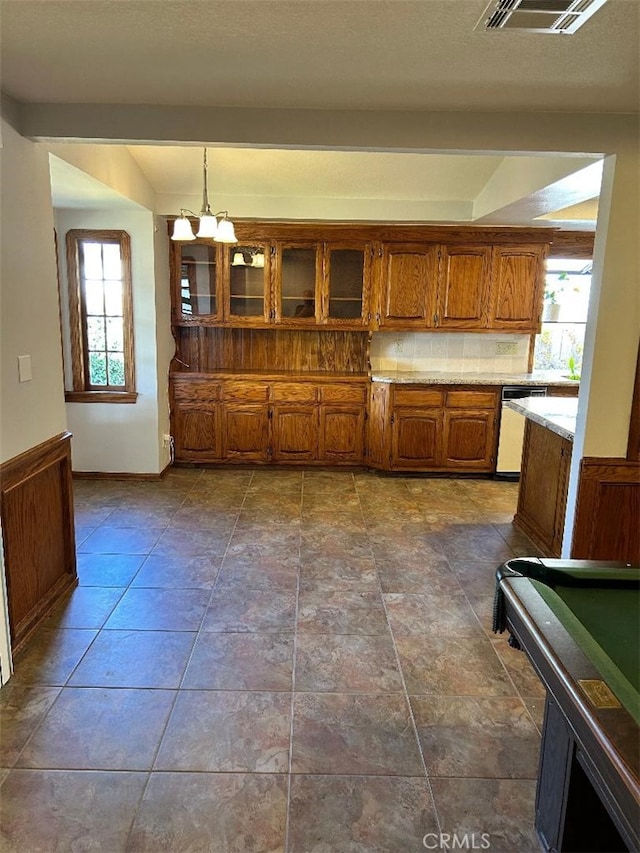 kitchen with dishwashing machine, an inviting chandelier, a wealth of natural light, and billiards