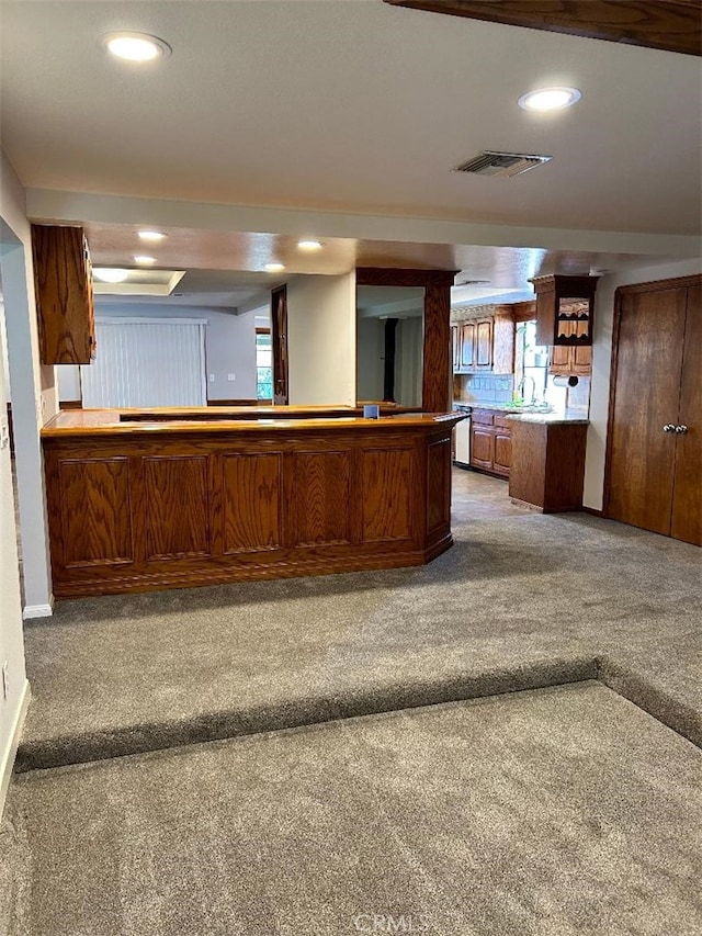 kitchen featuring carpet and kitchen peninsula