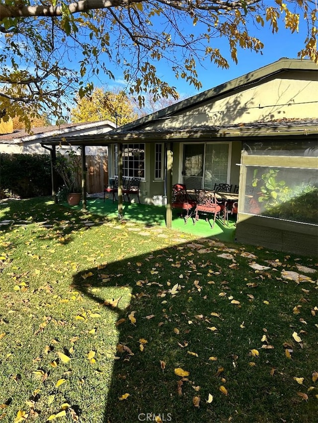 rear view of house with a lawn