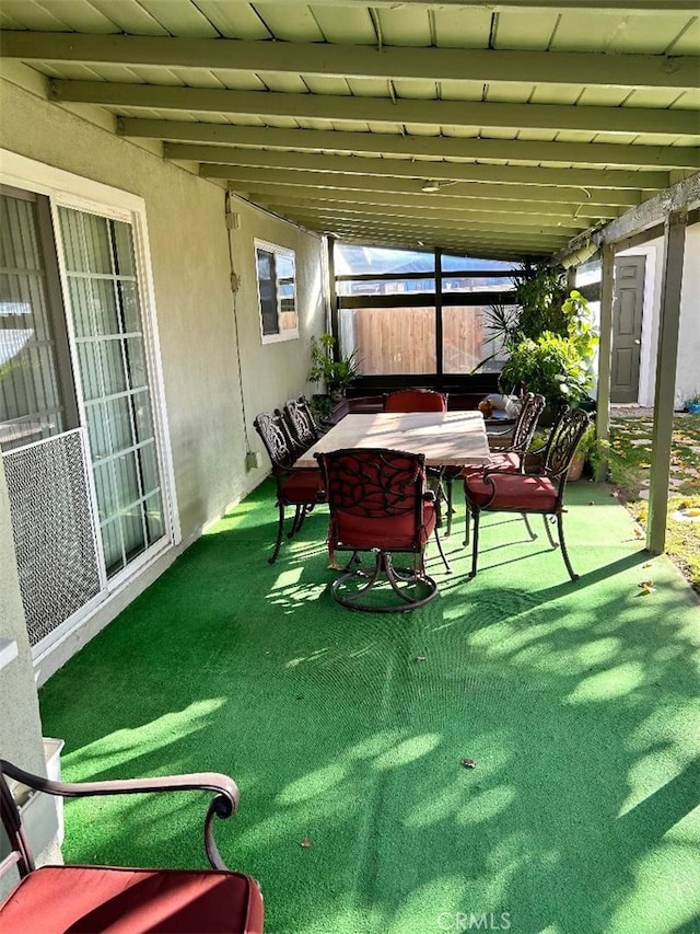 sunroom / solarium featuring vaulted ceiling