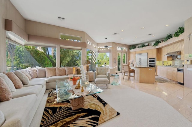 living room featuring light tile patterned floors and sink