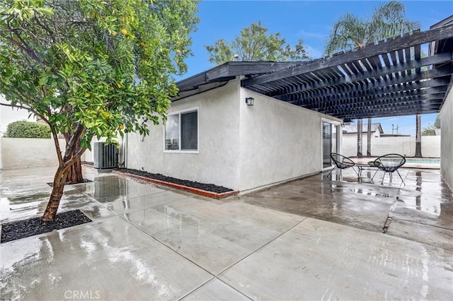 view of patio with a pergola and central AC unit