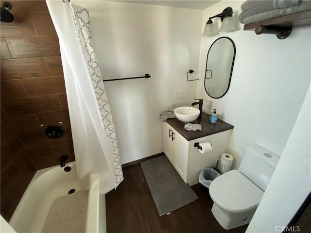 full bathroom with hardwood / wood-style floors, vanity, toilet, and shower / tub combo