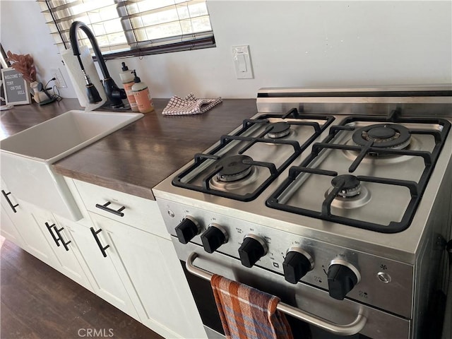 details with white cabinetry and stainless steel range with gas cooktop