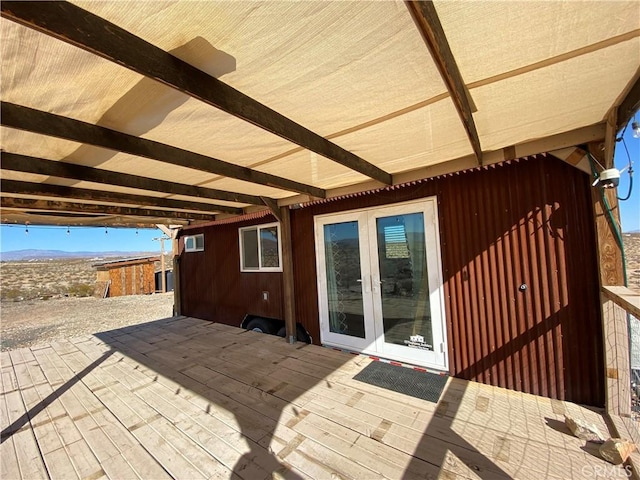 view of patio / terrace featuring a wooden deck and french doors