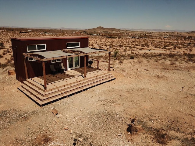 exterior space with a deck with mountain view