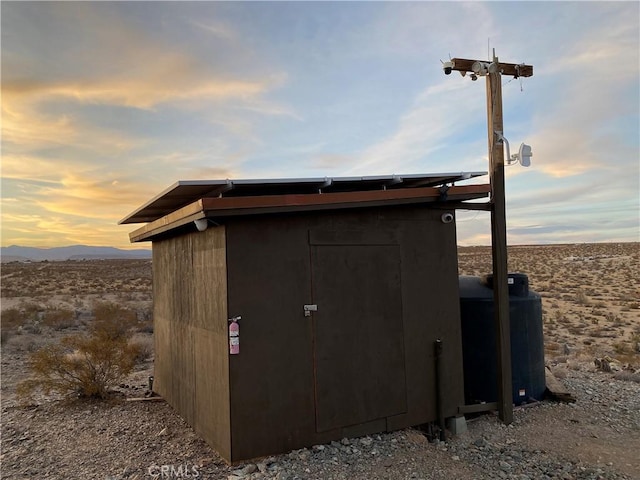 outdoor structure at dusk featuring a mountain view