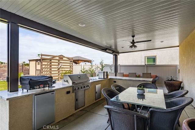 view of patio featuring a grill, ceiling fan, and area for grilling