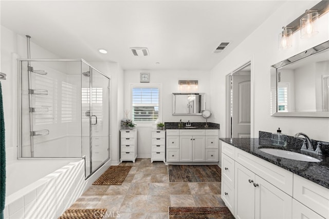 bathroom featuring vanity and plus walk in shower