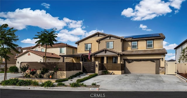 view of front of home featuring a garage and solar panels