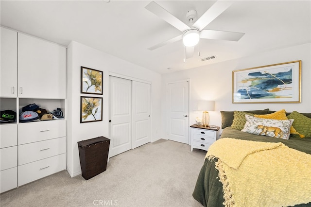 bedroom featuring a closet, light colored carpet, and ceiling fan