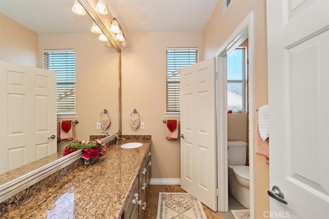 bathroom featuring tile patterned floors, vanity, and toilet