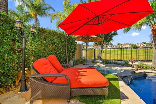 view of pool with pool water feature and a patio area