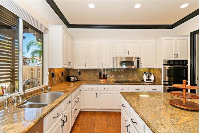 kitchen featuring white cabinets, stainless steel appliances, and sink