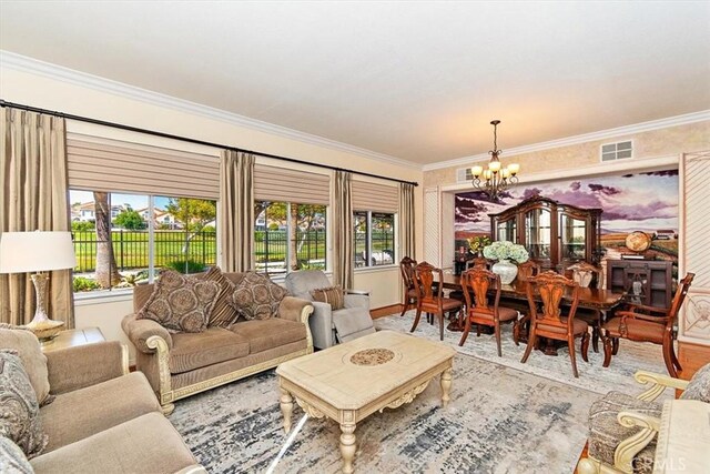 living room featuring plenty of natural light, ornamental molding, and an inviting chandelier